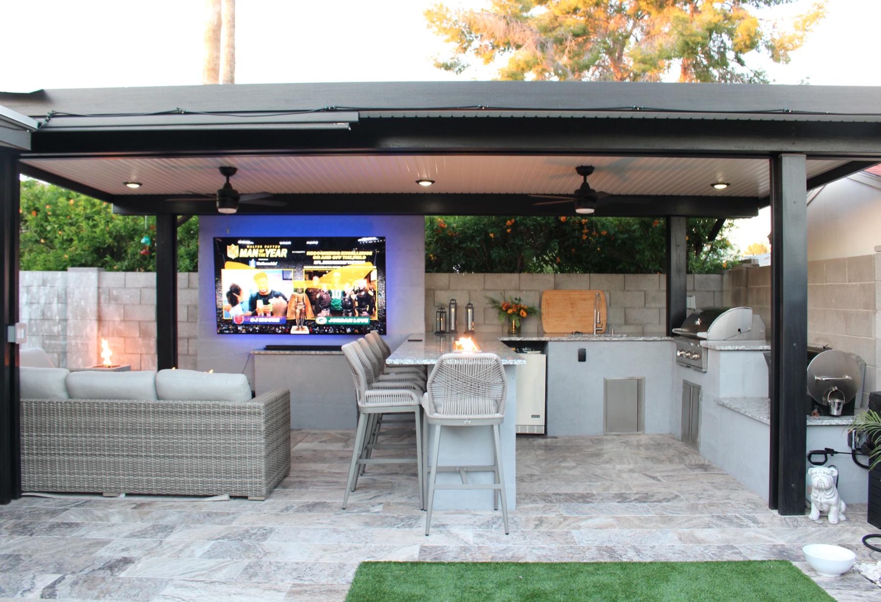 Outdoor entertaining patio with louvered roof, fire features, and integrated outdoor kitchen — Valley Pergola install